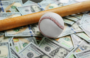 Baseball and bat on dollars background. Corruption concept